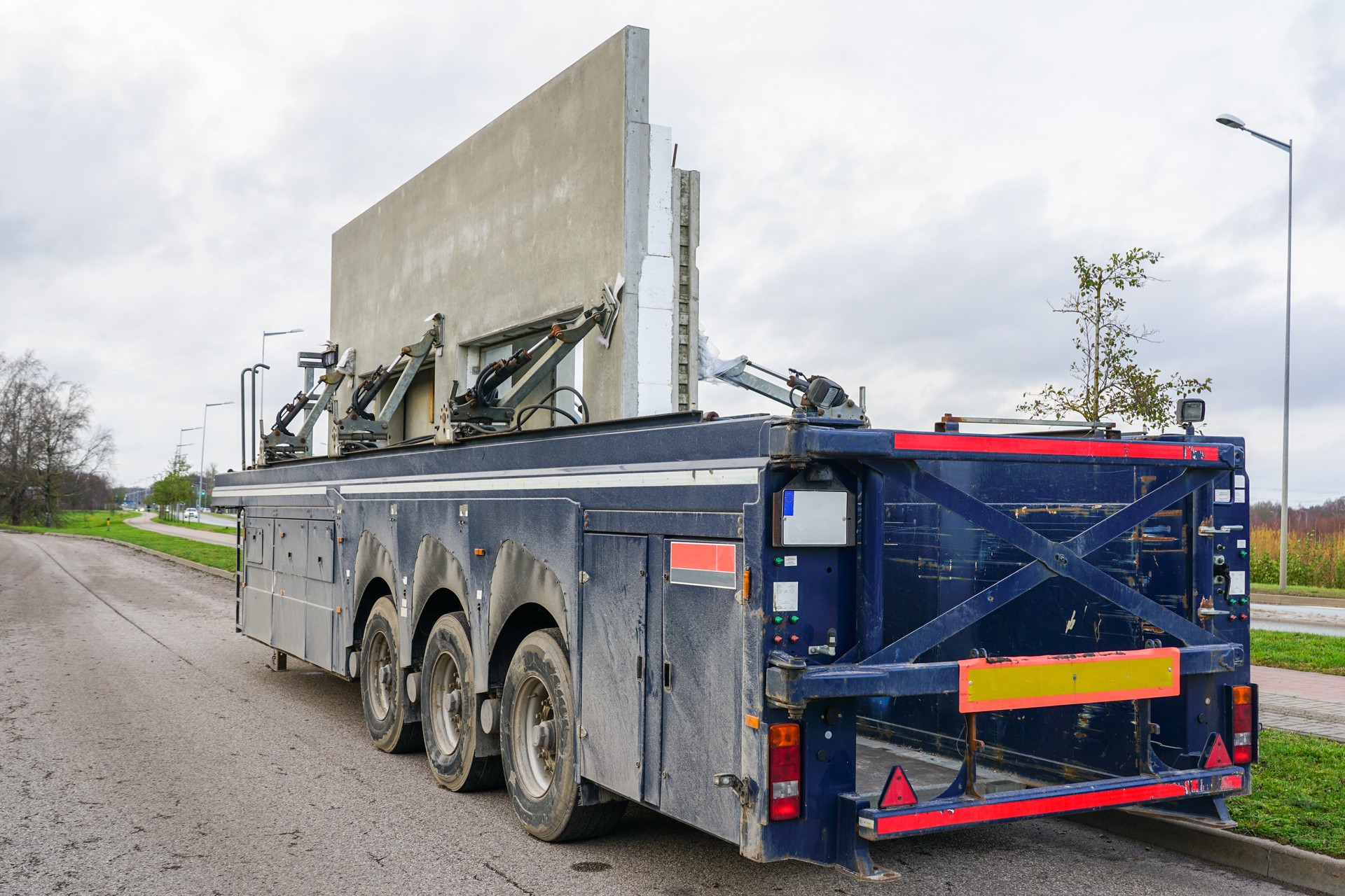 Transportation of reinforced concrete precast wall panels with a specialized low loader semi-trailer